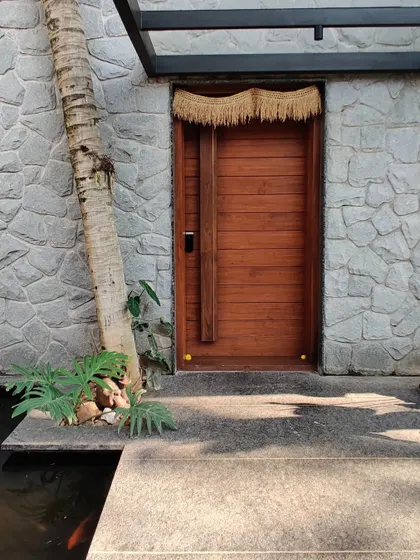 The entrance to Siri is designed to be a tranquil experience, with the sound of water from the koi pond and the texture of natural materials.