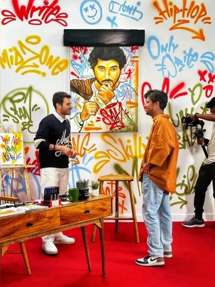A candid shot of me and Divyenndu on set, talking about the artwork. It’s always great to connect with the people I paint and share the creative process.