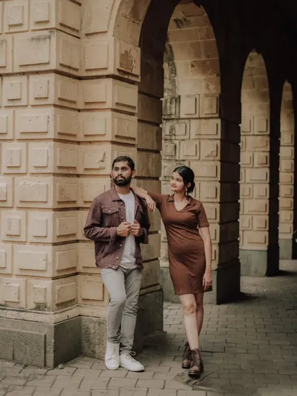A cool, editorial-style pose against the textured walls of a heritage building in Mumbai. This shot showcases Pragati and Swapnil's modern style.