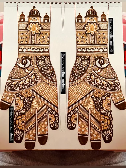 This symmetrical design for both hands, featuring palace-style tops, is first perfected on paper. This method ensures the final application on the bride's hands is flawless.