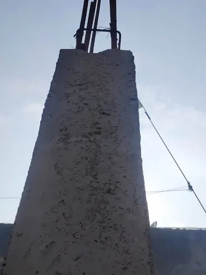 A close-up of a reinforced concrete column, the backbone of the structure.