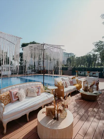 For a relaxed, boho-chic vibe by the pool, I used macrame umbrellas and elegant white sofas. This setup provided a comfortable and stylish lounge area for guests to enjoy the poolside Haldi festivities.