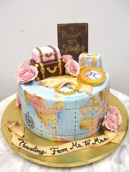 A cake for the journey from Ms. to Mrs. This travel-themed bridal shower cake features a hand-painted world map, vintage luggage, and a passport topper, telling a beautiful story of love and adventure.