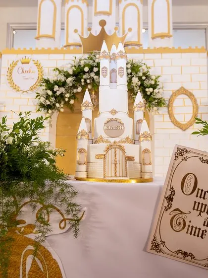 A detailed view of the "Once Upon a Time" setup, featuring the intricate castle cake, custom signage, and lush greenery that brought this fairytale theme to life.