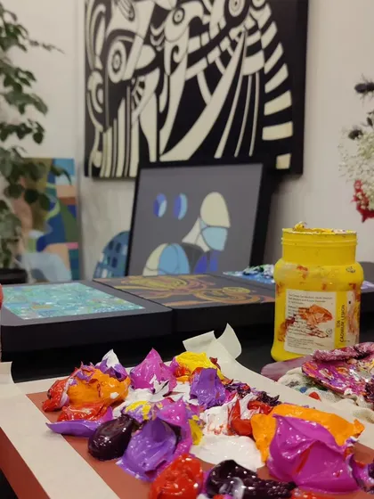 Another shot of the vibrant studio environment, with multiple projects and paint pots indicating a hub of constant creation.
