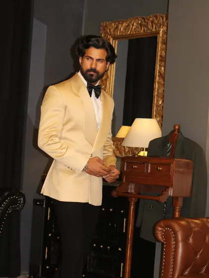 The clean lines of the ivory shawl lapel tuxedo are perfect for creating a sharp, memorable silhouette.