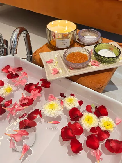 A close-up of the details that make our pedicure spa special. I use natural ingredients, fresh flower petals, and soothing candles to create a truly sensory experience that calms your mind while treating your feet.