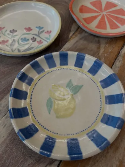 Just look at these beautiful plates painted by people in our workshops. It's amazing to see everyone's unique style come to life with color and glaze.