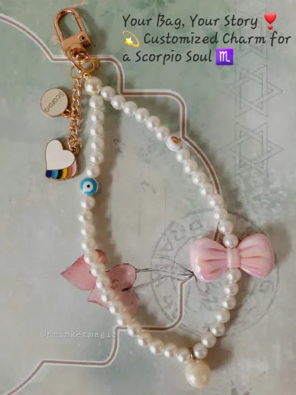 This is what I mean by making it personal. I created this custom pearl bag charm for a Scorpio, complete with a pastel bow, an evil eye for protection, and a rainbow heart. We can design one that tells your story, too.