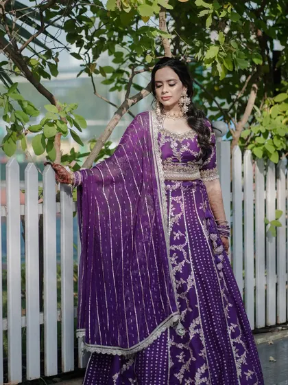 A full length shot of Dr. Archita's stunning Lagan Lakhvanu look. The makeup and hairstyle are elegant and traditional.