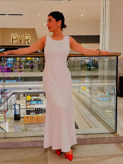 Posing at a mall in my white dress and red heels. This look proves that with the right styling, any piece can become a statement.