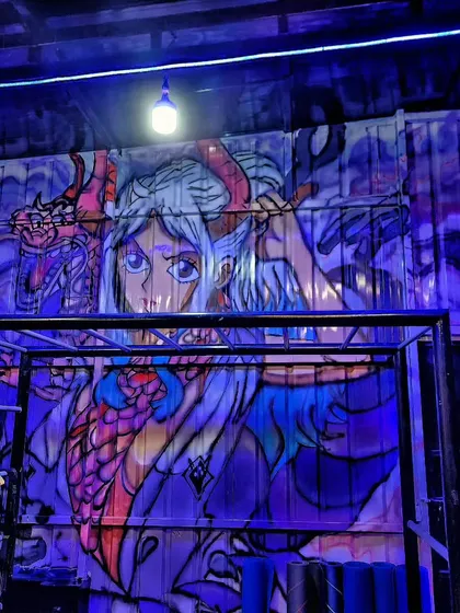 For Rfit Studios, we painted this mural of the anime character Yamato from One Piece on a corrugated container wall, bringing a dose of pop culture energy to the gym.