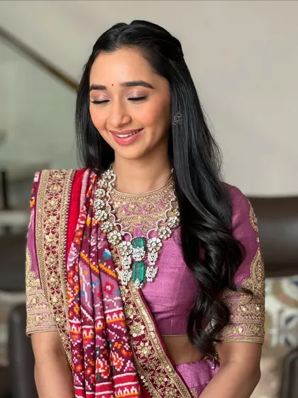 A close-up of the Pooja look, with eyes closed to show the soft, shimmery eyeshadow. The skin is kept fresh and luminous.