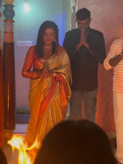 A traditional moment from the housewarming ceremony, with Sonu participating in the rituals.