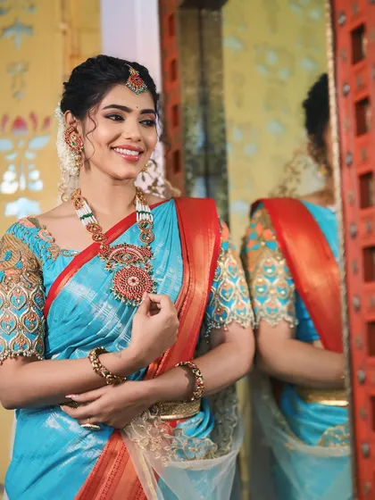A happy and radiant look. The makeup features a subtle shimmer on the eyes and a natural lip color that enhances her beautiful smile.