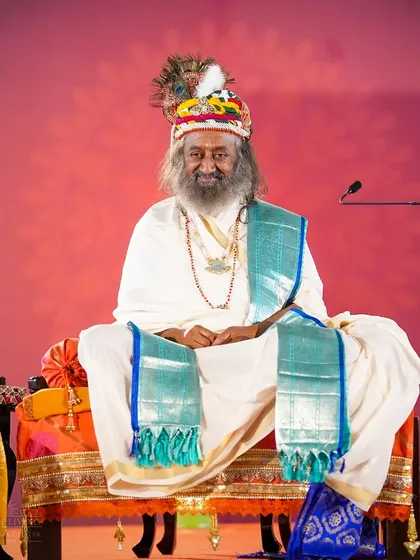 I am seated on a decorated stage for the Janmashtami celebration. The entire atmosphere is designed to transport everyone to the times of Lord Krishna in Vrindavan.