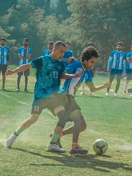 A gritty, determined tackle in the midfield during a corporate showdown.