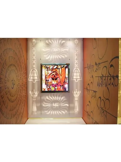 A modern mandir room with custom wallpaper featuring Sanskrit shlokas and a backlit Corian panel.