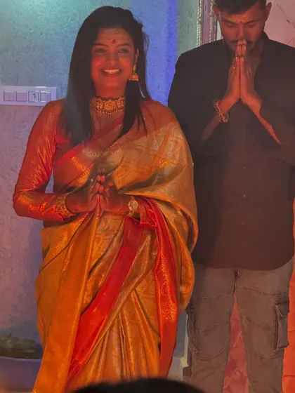 Sonu and her brother during the puja, a beautiful family moment.