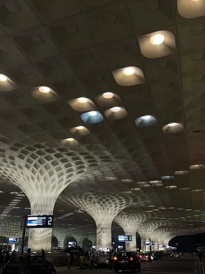 The illuminated ceiling and pillars of Mumbai's T2 terminal at night, creating a mesmerizing architectural pattern.