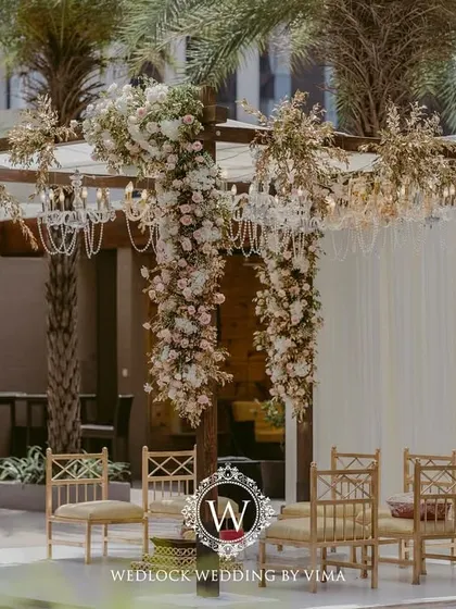 For this Punjabi wedding, we designed a subtle and elegant poolside mandap. The decor featured light fabrics, soft peachy-pink florals, and hints of gold to complement the serene setting.