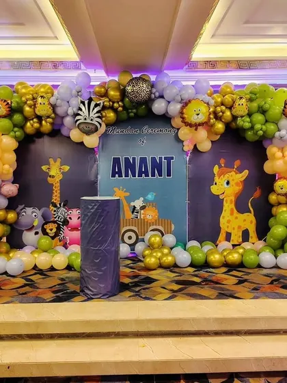 A close-up of the jungle-themed stage for Anant's Mundan ceremony, showing the detailed balloon arch and custom backdrop.