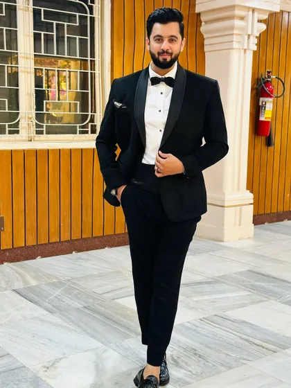 A full-length shot of my classic black tuxedo. This timeless look is perfect for the most formal events, ensuring I look as professional as my performance.