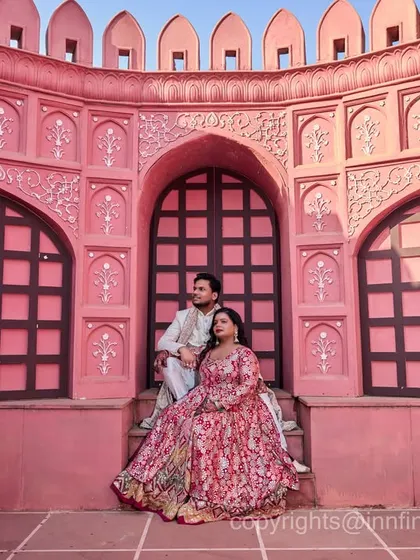 The intricate details and rich color of our pink palace set create a stunning backdrop for a regal couple portrait.