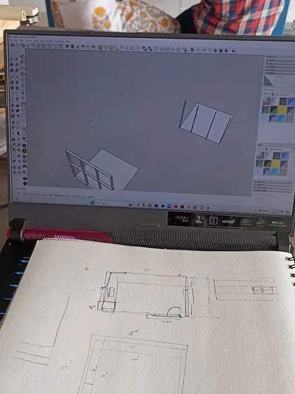 The design process often starts with a simple sketch and a digital model before moving to the physical prototype. This image shows the journey from a 2D idea to a 3D plan.