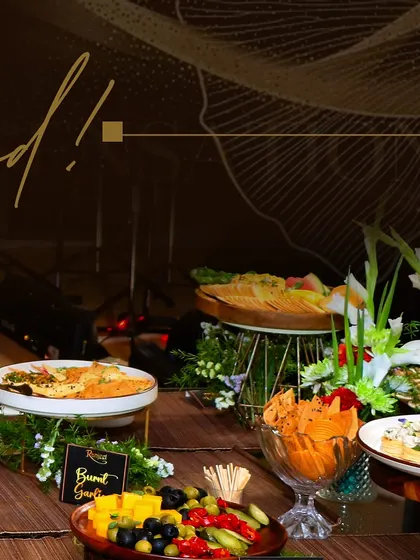 A closer look at our grazing table offerings, including burnt garlic hummus, assorted crackers, and a selection of olives and pickled vegetables, all beautifully presented.