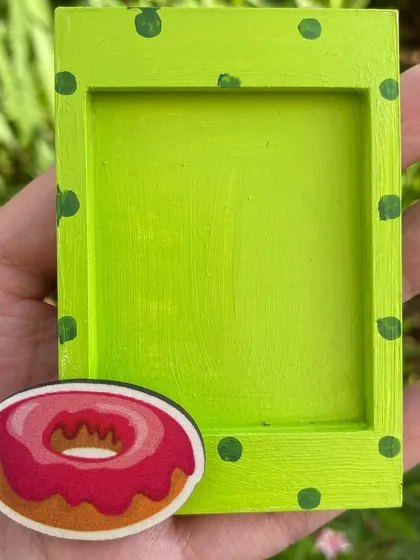 This donut-themed photo magnet is a fun and colorful way to frame a small picture.