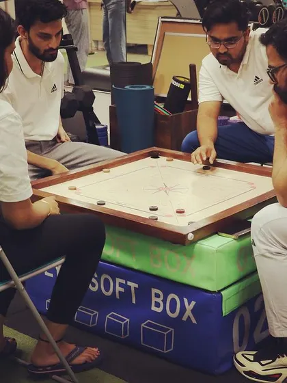 The concentration during a team carrom match. It's all about strategy, whether in the clinic or at play.