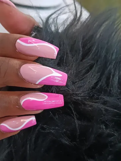 A close-up of the fun and graphic pink swirl nail art.
