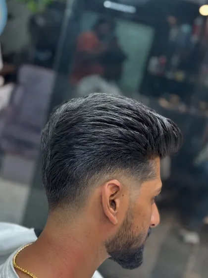 A side profile of a classic haircut with a taper fade and natural volume.