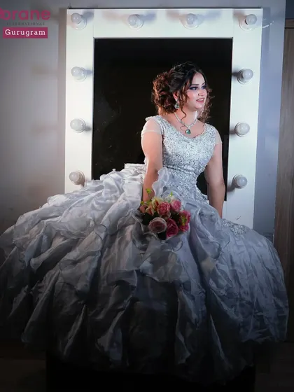 A beautiful shot of a student's work, featuring a model in a voluminous gown in front of a vanity mirror. This captures the dream and glamour of the beauty profession.