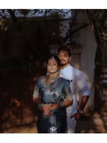 An artistic portrait of a couple, with sunlight and shadow creating a dramatic and romantic mood.