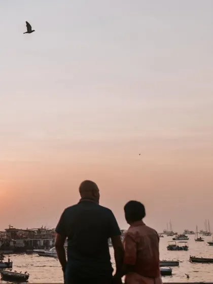 Watching the sunset over the Mumbai harbor. This silhouette shot captures a peaceful, reflective moment at the end of our photo session.