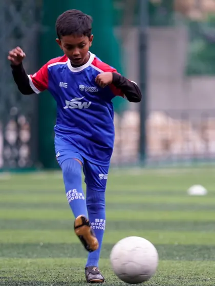 A young player strikes the ball with focus. Every training session is an opportunity to improve technique and build confidence.