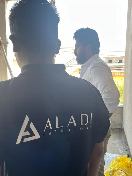 A photo of my team member on-site, proudly wearing the Aladi Interiors branded shirt, symbolizing our team's dedication.