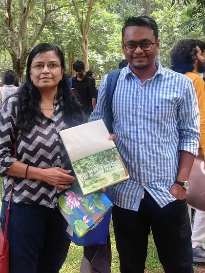 With a fellow artist at Cubbon Park, showcasing the art we created during our outdoor painting session.