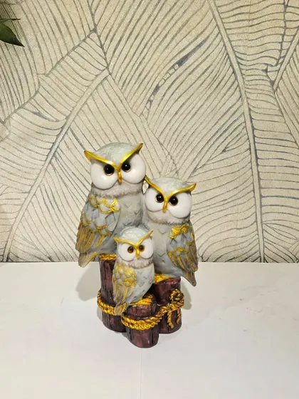 A beautiful showpiece of an owl family in a grey and gold finish, symbolizing protection and family bonds.