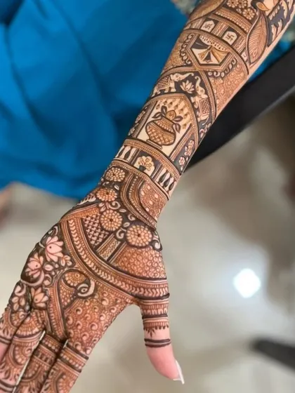 A side view of a full-arm design, highlighting the floral and traditional bands that wrap around the arm.