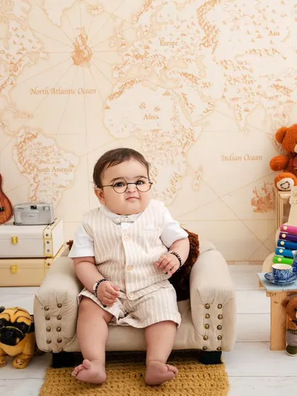 A studious little gentleman, looking very serious and cute in his glasses, ready to explore the world through books.