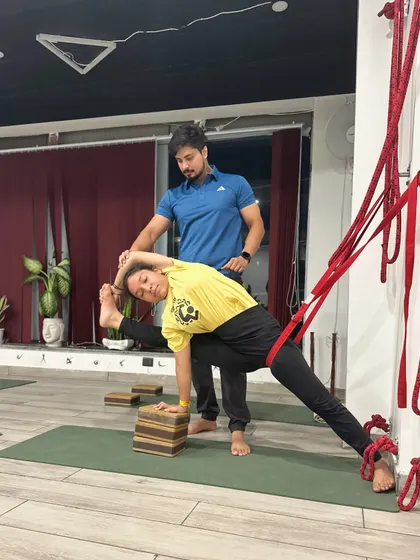 In Iyengar Yoga, props like belts are essential for precision. Here, a belt stabilizes the femur, ensuring proper alignment and preventing strain on the hip and knee joints. This provides a deeper, more mindful, and safer practice.