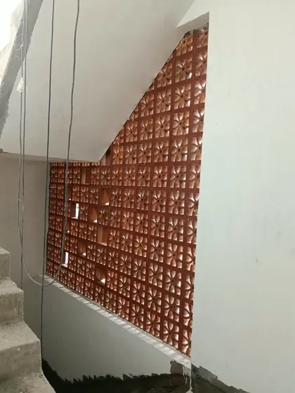 An innovative use of a jali screen along a staircase. This custom-fit installation adds a significant design element to the space while also serving as a beautiful and safe railing.