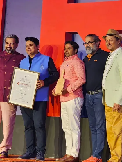 Another angle of the team receiving the award on stage.