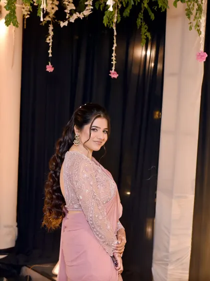 Upasana looking gorgeous for her parents' 25th anniversary. We gave her long, flowing mermaid curls and a soft pink makeup look to match her beautiful saree.