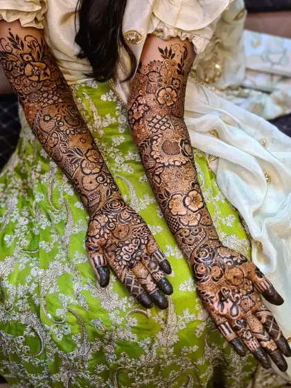 An elbow-length bridal design with a dense combination of flowers and paisleys. The fine line work and detailed fillers ensure a breathtaking result.