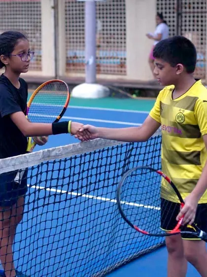 Sportsmanship is a core value we teach at Tennace Academy. Win or lose, we encourage our players to respect their opponents, as seen here with a handshake over the net after a practice match.