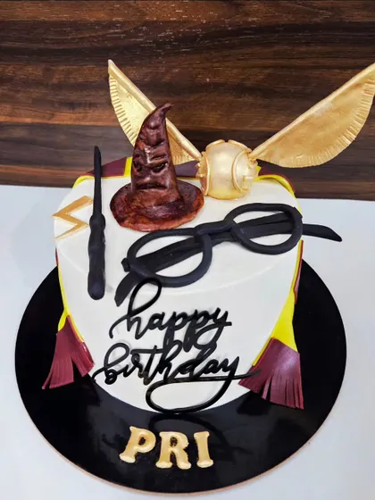 A Harry Potter cake for Pri's birthday. This chocolate truffle cake is a magical creation with a sorting hat, golden snitch, and wand, all made from fondant.